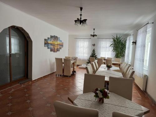 a large dining room with tables and chairs at Pensiunea Paula in Moieciu de Sus