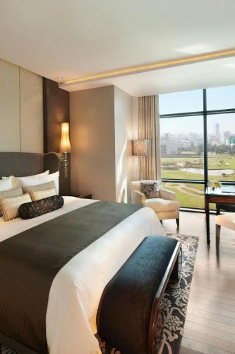 a bedroom with a large bed and a large window at The St. Regis Bangkok in Bangkok