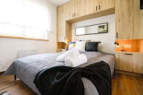 a bedroom with a large bed with two towels on it at Németh Vendégház in Lepsény