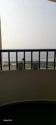 two baskets sitting on a railing near a window at Seashells Pentagon Calicutbeach in Kozhikode