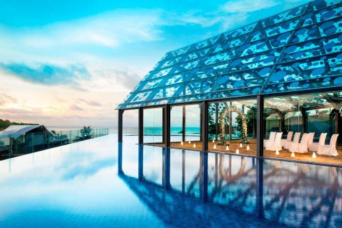 a building with a pool on top of it at Le Meridien Bali Jimbaran in Jimbaran