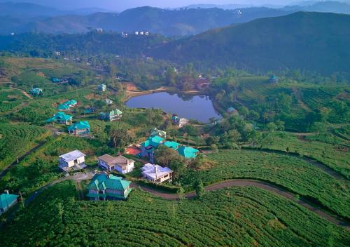 an aerial view of a house on a hill with a lake at Priyas Villa Vagamon by VOYE HOMES-Scenic Mountain View in Vagamon