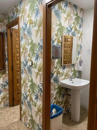 a bathroom with a sink and a mirror at El Refugio Valdelinares Gastro Hostal in Valdelinares