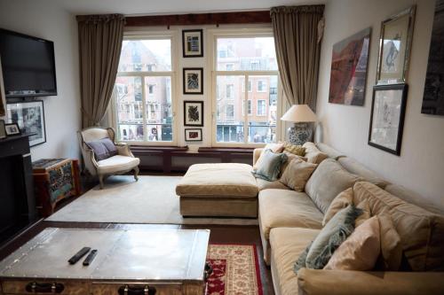 a living room with a couch and a table at redlight canalview city centre in Amsterdam
