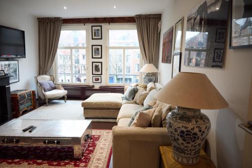 a living room with a couch and a table at redlight canalview city centre in Amsterdam