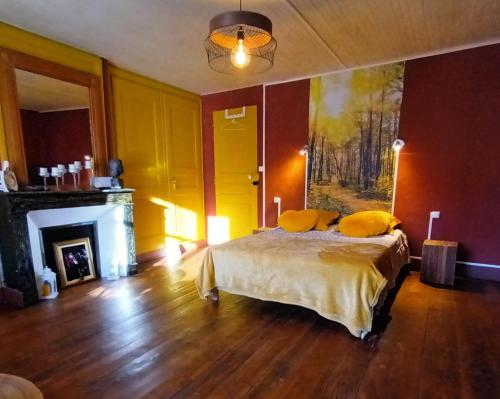 une chambre avec un lit avec des oreillers jaunes dessus dans l'établissement Au Mange-Prunes, à Auzon