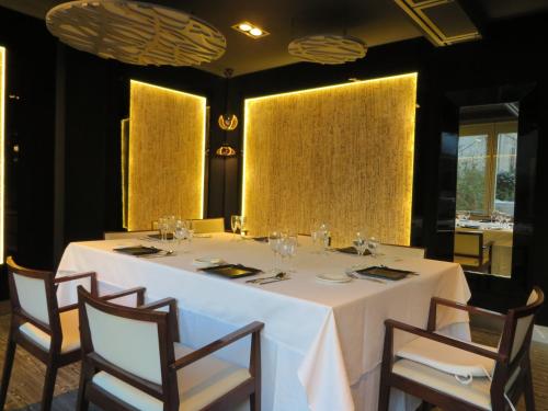 a dining room with a white table and chairs at Evenia Rossello in Barcelona