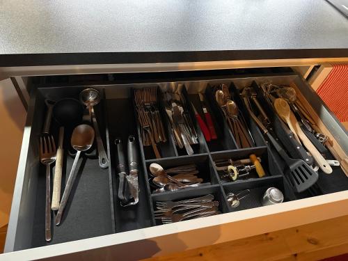 a drawer filled with utensils and utensils at Blockhausvermietung Himmelpfort in Pian