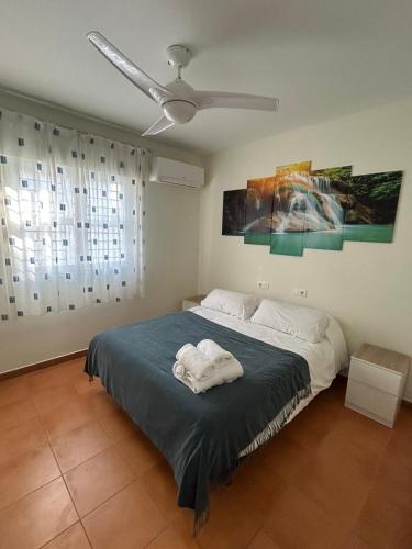 a bedroom with a bed with a ceiling fan at Relax, Family, Telecommuting & Private Pool in Vélez-Málaga