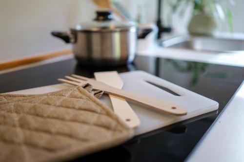 a cutting board with utensils on a counter in a kitchen at Oltrebosco Casa Vacanze in Valfabbrica