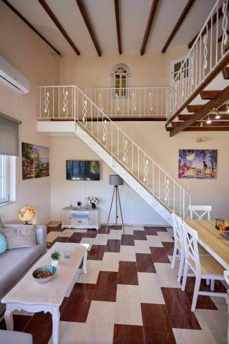 a living room with a staircase and a couch at Sweet Cottage In The City in Chios
