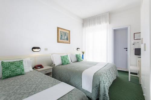 Säng eller sängar i ett rum på Hotel Gioiello