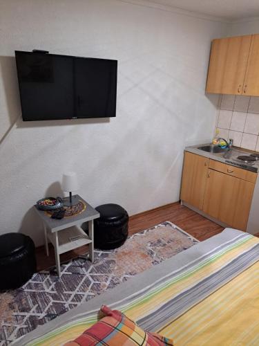 a room with a flat screen tv on a wall at Apartmani Konta in Livno