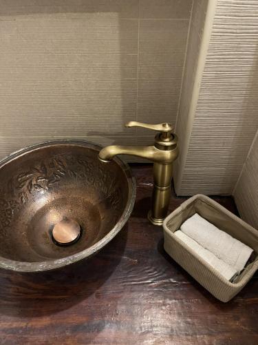 a bathroom with a copper sink and a faucet at Bayt Wadad, Bcharre Lebanon in Bcharré
