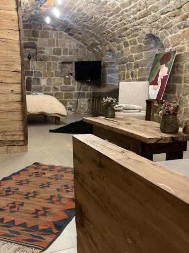 a living room with a table and a tv at Bayt Wadad, Bcharre Lebanon in Bcharré