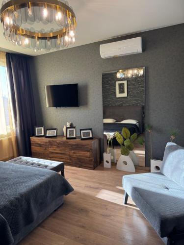 a bedroom with a bed and a large mirror at Apartments Lux in city center Lviv in Lviv