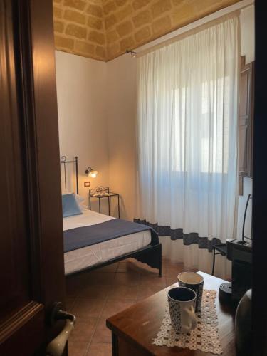 Ένα ή περισσότερα κρεβάτια σε δωμάτιο στο Ai Dammusi Rooms