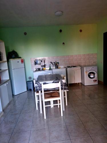 a kitchen with a table and a sink and a washing machine at Memela House in Poggio Mirteto