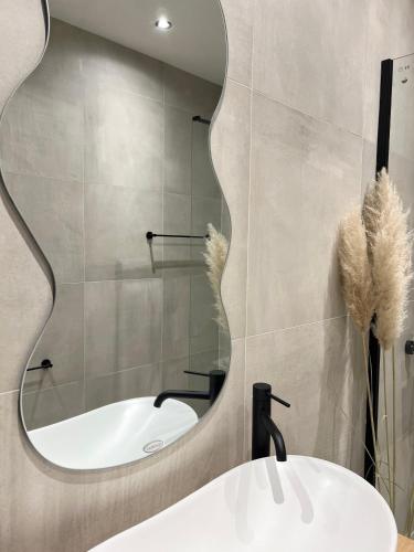 a bathroom with a sink and a mirror at Home Away From Home 2 in Jajce