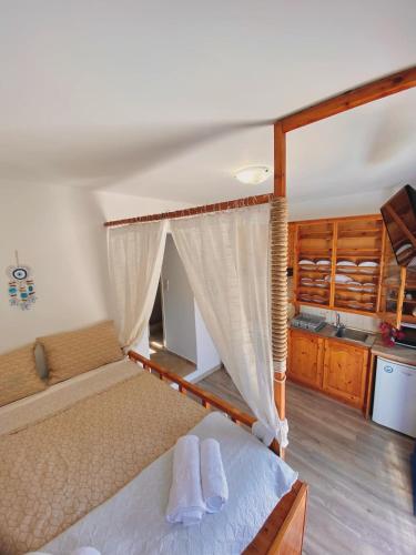 a bedroom with a bed with two towels on it at Emborios Views - Studio in Emborios
