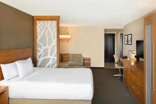 a hotel room with a bed and a desk at Courtyard by Marriott La Paz Baja California Sur in La Paz