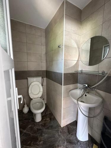 a bathroom with a toilet and a sink at Heaven Apartments in Ulcinj