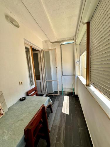 an empty room with a bed and a window at Heaven Apartments in Ulcinj