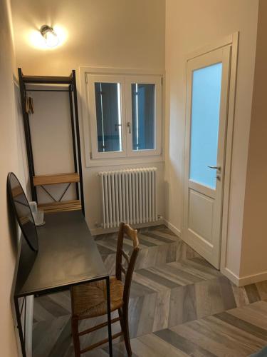a room with a table and a chair and a mirror at B&B La Marjolaine di Ale e Madda in Fagagna
