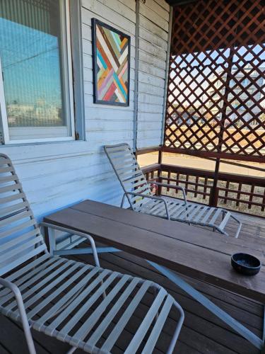 two chairs and a wooden table on a porch at Sokcho Daemyung Pension in Sokcho