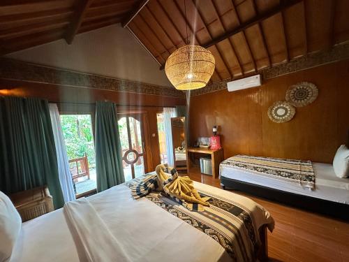 a bedroom with two beds and a large window at Sunny Rose Bungalows Gili Air - Adults only in Gili Air