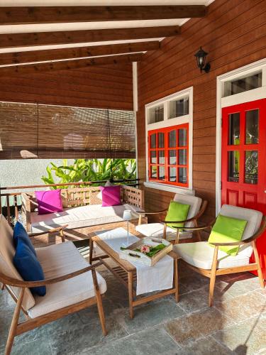 a group of chairs and tables on a patio at Ambiance Villa in La Digue