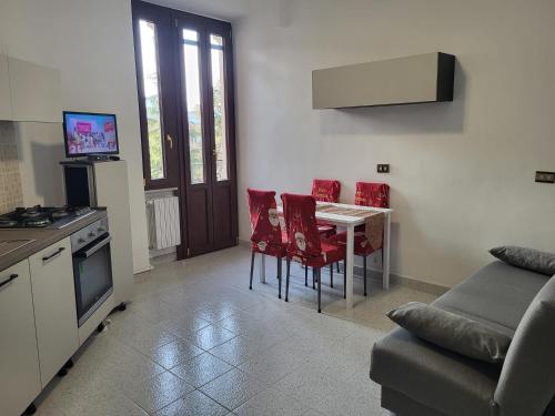 a kitchen and living room with a table and chairs at Casa Valeria in Sulmona
