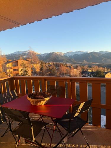 a table with a bowl of food on a balcony at la terrasse du belvédère in Font-Romeu