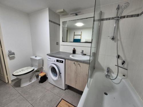 une salle de bain avec un lavabo et une machine à laver dans l'établissement Le Grand Large T2 climatisé à 200 m plage, parking, à Sète