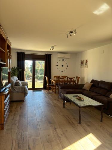a living room with a couch and a table at El Hondón del Lugar in Hoyos
