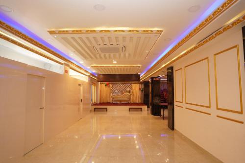 a hallway with a room with a ceiling with blue lights at Hotel Faben Inn in Itahari