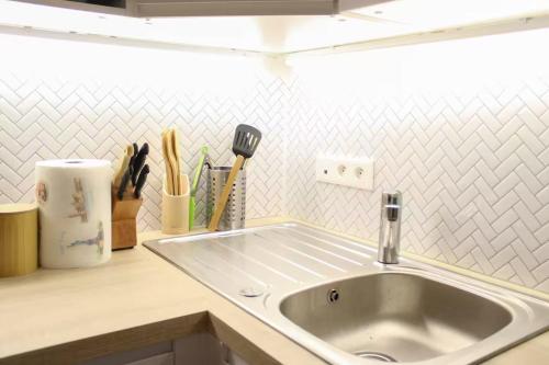 a kitchen counter with a sink in a kitchen at Bright and comfortable 28m2 Studio in Vanves in Vanves