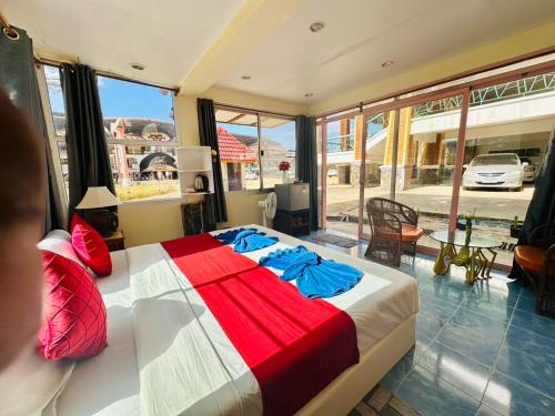 a bedroom with a large bed with red and white sheets at House 2 Bedroom full river view near beach in Ko Chang