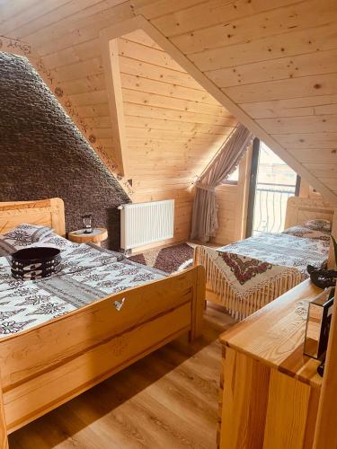 a large room with two beds in a attic at Izby na Równi in Witów