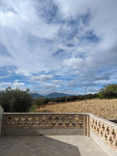 a brick wall with a view of a field at Country House 3Quatrì in Corropoli