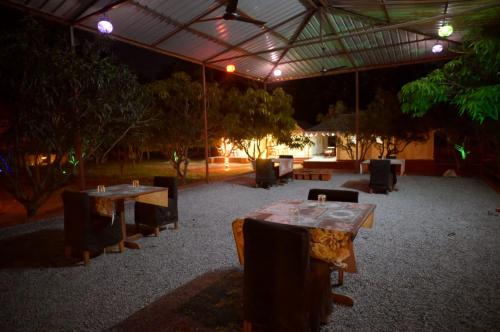 a group of tables and chairs under a tent at Mango Farm Villa in Thūr
