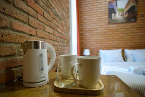 two coffee makers sitting on a wooden table at Hotel Mogzauri in Tbilisi City