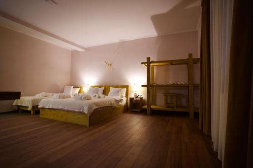 a bedroom with two beds in a room at Hotel Mogzauri in Tbilisi City