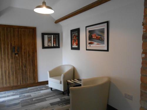 a waiting room with a chair and a desk at Callwood Farm Annex Guest Rooms in Belper