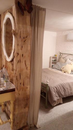 a bedroom with a bed and a mirror on the wall at La Tana del Nano in Ancona