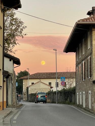a car driving down a street with the sun in the sky at B&B La Marjolaine di Ale e Madda in Fagagna