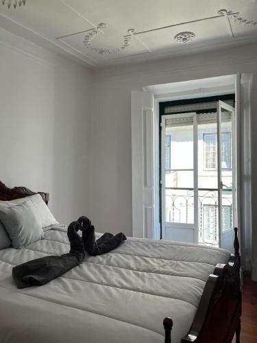 a bedroom with a bed with a stuffed animal on it at Lisboa Príncipe Real Home - Casa de Hóspedes in Lisbon