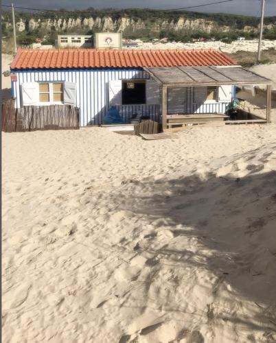 a building on the beach with a sandy beach at Lisbon Beach Hut - Costa Caparica in Costa da Caparica