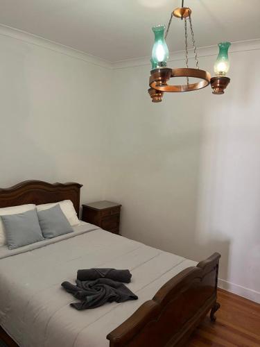 a bedroom with a bed and a chandelier at Lisboa Príncipe Real Home - Casa de Hóspedes in Lisbon