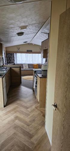 an open door to a kitchen in an rv at Bittern 22, Parkdean, California Cliffs, Scratby, sleeps 6, free wi-fi, bedding and towels included, 5 mins from beach in Great Yarmouth